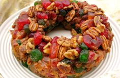 a fruit and nut cake on a white plate