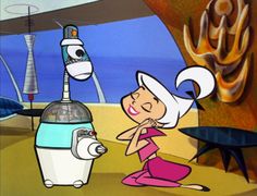 an animated cartoon character next to a blender in front of a table with food on it