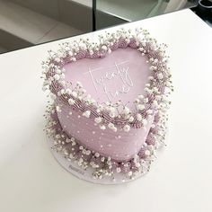 a heart shaped cake with flowers on top