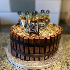 there is a chocolate cake with liquor bottles on it