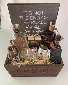 a wooden box filled with lots of liquor and other items that are on top of a table