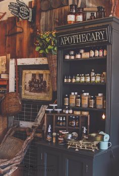 an antique pharmacy cabinet with bottles and jars on it's shelves in a shop