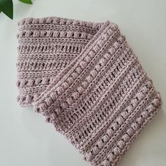 two crocheted dishcloths sitting next to each other on a white surface