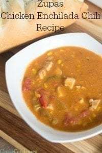 a bowl of chicken enchilada chili soup next to a loaf of bread