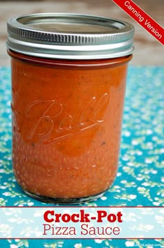 a jar filled with pizza sauce sitting on top of a blue and white tablecloth