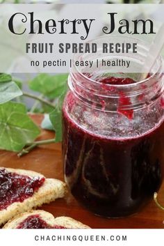 a jar filled with jam next to slices of bread and cherries on a cutting board