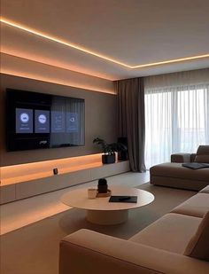 a living room with couches and a flat screen tv mounted on the wall above it