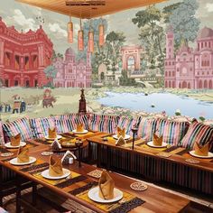 a restaurant with colorful wallpaper and tables set up for a formal meal or dinner