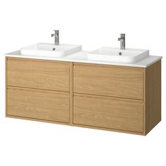 two white sinks sitting on top of a wooden cabinet