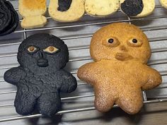 three cookies with faces and eyes are on a rack