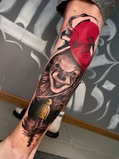 a man's leg with a tattoo on it that has a clown and a red hat