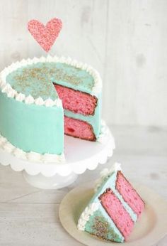 a pink and blue cake sitting on top of a white plate