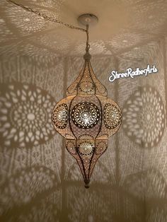 an intricately designed chandelier hangs from the ceiling