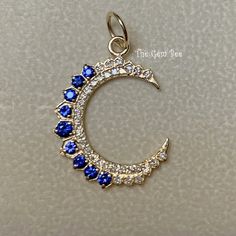 "Thank you for coming in! Genuine 14K GOLD diamond natural sapphire charm pendant. This particular Yellow gold large moon charm has small diamond accents(0.25 carat) and natural blue sapphire stones(0.44 carat) on it! THEY ARE STAMPED WITH \"14K 0.25ct\", but I could not show it clearly in the pictures. Amazing quality diamonds and finest royal blue sapphire stones in this piece!  DIMENSION: 18mmx24.5mm including 3.5mm jump ring, plus 6.3 mm top bail loop, 4.5mm hole MATERIAL: 14K Yellow Gold,  natural diamond, natural blue sapphire" Celestial Style Sapphire Jewelry In Sterling Silver, Celestial Blue Sapphire Jewelry, Celestial Sapphire Sterling Silver Jewelry, Celestial Sapphire Gemstone Jewelry, Elegant Blue Jewelry With Moon Charm, Luxury Yellow Gold Jewelry With Moon Charm, Celestial Pendant Jewelry With Cubic Zirconia, Celestial Sapphire Jewelry In 14k Gold, Cubic Zirconia Moon Charm Jewelry