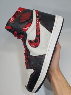 Introducing  our custom-made Air Jordan 1s, handcrafted from premium high-quality leather with a unique handmade swoosh featuring a bold bandana theme, and a luxury lambskin interior. These sneakers are a true fusion of classic style and trendy design, making them the ultimate statement piece for any sneakerhead. Expertly crafted from scratch, each pair offers a comfortable fit and unbeatable durability. The bandana-themed swoosh adds a bold touch to the iconic Air Jordan 1 silhouette, creating a truly one-of-a-kind sneaker that's sure to turn heads wherever you go. Don't settle for ordinary sneakers. Upgrade to our custom-made Air Jordan 1s and experience the ultimate in sneaker style. Once your order is placed, you will be updated throughout the process via email to keep you updated at a Red Custom Sneakers For Streetwear, Custom Red Sneakers For Streetwear, Luxury Custom Sneakers With Laces For Streetwear, Custom Leather Sneakers With Laces For Streetwear, Leather Custom Sneakers With Laces For Streetwear, Custom Leather Sneakers, Custom Sneakers For Streetwear, Custom Leather Sneakers With Red Sole For Streetwear, Custom Leather Sneakers For Streetwear