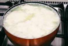 a pot filled with liquid sitting on top of a stove