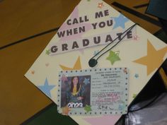 a decorated graduation cap with the words, call me when you graduate and a photo pinned to it