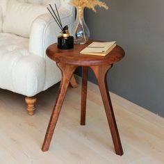 a white couch sitting next to a wooden table