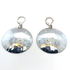 These lustrous drop earrings feature hammered sterling silver disks, adding a touch of class and elegance to any outfit. The unique texture and shine of these hammered design make these earrings a standout accessory. The sterling silver shimmers like a disco ball. Perfect for any occasion, they are a timeless addition to your jewelry collection. Marked "Sterling" and "ESS". FREE SHIPPING! Details: Sterling Silver: (as shown in picture) Drop Length: 2 inches Approximate Dimensions: 1 ¼ in x 1 ¼ in Total Weight (Together): 7.8 grams FREE domestic shipping by USPS Priority Mail with delivery confirmation and insurance included. For international shipping, Etsy will calculate postage. Please notify us at purchase if you are buying more than one item, and we will gladly combine shipping. 7-day Hammered Sterling Silver Round Disc Earrings, Elegant Silver Disc Earrings, Hammered Metal Round Earrings, Modern Silver Round Disc Earrings, Nickel-free Silver Round Disc Earrings, Nickel Free Silver Round Disc Earrings, Silver Nickel-free Round Disc Earrings, Silver Hammered Drop Earrings, Hammered Silver Round Disc Earrings