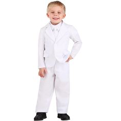 a little boy in a white suit and tie standing with his hands on his hips