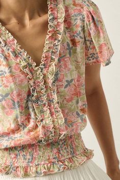 Floral-print crepe blouse. V neckline with smocked ruffle trim. Short bell sleeves. Smocked elastic hem with ruffle. Buttoned keyhole back closure. Relaxed fit. 100% Rayon. Imported. Designed in LA. Model wears size S. Floral Outfit Summer, Ruffle Trim Top, Floral Ruffle Top, Rib Dress, Natural Blush, Crepe Blouse, White Coral, Eye Makeup Tips, Trim Top