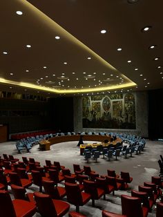 an empty conference room with red chairs