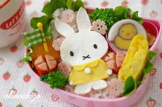 a close up of a plate of food with an image of a rabbit on it