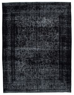 a black and white rug with an intricate design on the middle, it is very dark