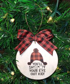 a wooden ornament hanging on a christmas tree that says, you'll shoot your eye out kid