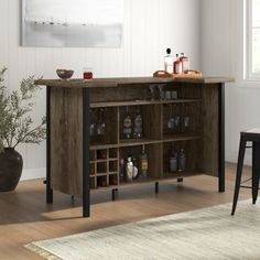 a bar with wine glasses and bottles on it in the corner of a living room