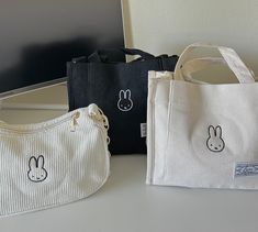 bags inspired by miffy! bags are corduroy material. they have pockets on the inside as well as a button to latch the bag closed (shoulder bag). shoulder bag has a longer strap as well as a shorter strap. holds up very well! no problems with washing the bag and the embroidery won't budge at all.  i take custom commissions as well so feel free to message me if interested in that. can do miffy designs on tote bags just let me know FOR PERSONALIZATION: if you want a different thread color, feel free to say so in the personalization section or message me! Everyday White Kawaii Canvas Bag, White Harajuku Bag With Cute Design, Miffy Bag, Miffy Pouch, Miffy Stuff, Cute White Bag With Bunny Design, Miffy Coin Purse, Cute Everyday Bags With Bunny Design, Baguette Bags