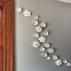 the wall is decorated with white paper flowers