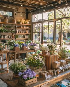 an indoor garden shop filled with lots of plants and flowers in wooden boxes on top of a table