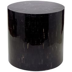 a black round table sitting on top of a white floor