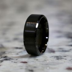 a black ceramic ring on a marble surface