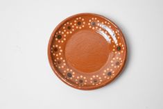 a brown and white plate with dots on it