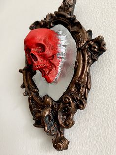 a mirror with a red skull in it