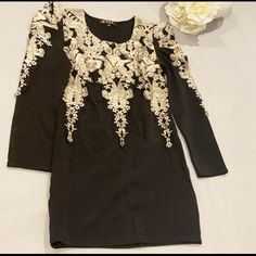 Black Dress With Gold Embroidery Fitted Long Sleeve Dress With Gold Embroidery, Long Sleeve Embroidered Dresses For Night Out, Elegant Mini Embroidered Dress With Floral Embroidery, Elegant Floral Embroidered Mini Dress, Elegant Mini Embroidered Floral Dress, Elegant Embroidered Dress With Embroidered Sleeves For Party, Elegant Embroidered Dress For Party With Gold Details, Elegant Embroidered Dress With Sleeves For Party, Elegant Gold Embroidered Dress For Party