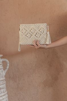 DescriptionStylish, sophisticated, and fun, this crochet macrame clutch is the perfect carrier for your daily necessities. Comes with a wristlet handle and strap for over your shoulder.Handwoven by The Women’s Workshop in Bali, Indonesia each purchase supports a single mother in her craft, providing her with a living wage while putting her children through school and supplying them with groceries to eat. MaterialsCotton Woven Cream Clutch For Everyday, White Bohemian Rectangular Clutch, Bohemian Handwoven Beige Clutch, Eco-friendly Woven Pouch Clutch, Eco-friendly Beige Woven Clutch, Daily Necessities, Crochet Clutch, Single Mothers, Tan Color