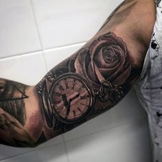 a man's arm with a clock and rose tattoo on it