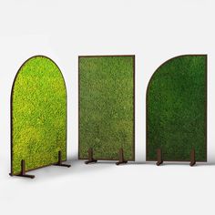 three doors with grass growing on them in the shape of archs, one open and one closed