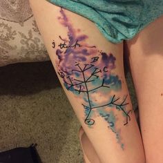 a woman's leg with a snowflake tattoo on it