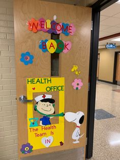 a door decorated with the words welcome back, health office and a cartoon character on it