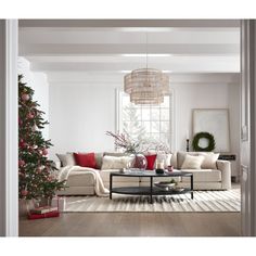 a living room filled with furniture and a christmas tree