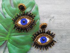 These beaded evil eye earrings would make a perfect and unique gift for family, friend, or yourself. ★READY TO SHIP Made with love and care about you!♥ ★DIMENSIONS: 6.5*6 cm (2.55*2.36 Inches) ★The colors can slightly differ from the photo because of photography lighting and monitor settings. ★ESTIMATED SHIPPING TIMES: North America: 2-4 weeks Europe: 1-3 weeks Australia, New Zealand and Oceania: 3-5 weeks Asia Pacific: 2-4 weeks Latin America and the Caribbean: 3-5 weeks North Africa and the Middle East: 3-5 weeks Sub-Saharan Africa: 3-5 weeks ★PLEASE NOTE: I accept payments through Paypal * you no need to have an account* by credit or debit card. 1. Click Check out with PayPal and you'll be redirected to PayPal. Instead of choosing to pay with your PayPal account, select Pay with Debit o African Necklace, Evil Eye Earrings, Eye Earrings, Handmade Beaded Jewelry, Large Earrings, Evil Eye Jewelry, Chandelier Earrings, Evil Eye, Beaded Embroidery