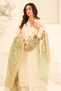 Illuminate your wardrobe with our expertly crafted White and Green Shalwar Kameez. Made with luxurious khaadi silk, intricately embroidered with motifs and embellished with dabka and beads for a touch of elegance. Complete your look with our jamawar organza mint green dupatta for a perfect finish. Perfect for formal events and special occasions. Elegant Jamawar Salwar Kameez For Wedding, Elegant Jamawar Lawn Suit For Festivals, Elegant Jamawar Lawn Suit For Wedding, Elegant Jamawar Salwar Kameez For Festivals, Semi-stitched Raw Silk Kurta With Dabka Work, Elegant Lawn Suit With Dabka For Festivals, Festive Eid Sharara With Naqshi Detailing, Elegant Naqshi Sharara For Festivals, Festive Naqshi Sharara