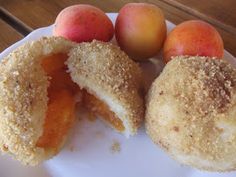 two donuts and three peaches on a plate