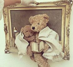 two teddy bears are sitting in front of a framed photo with an old - fashioned frame