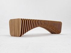 a wooden bench made out of strips of wood sitting on top of a white floor