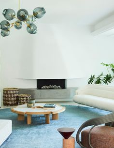 a modern living room with white walls and blue carpet